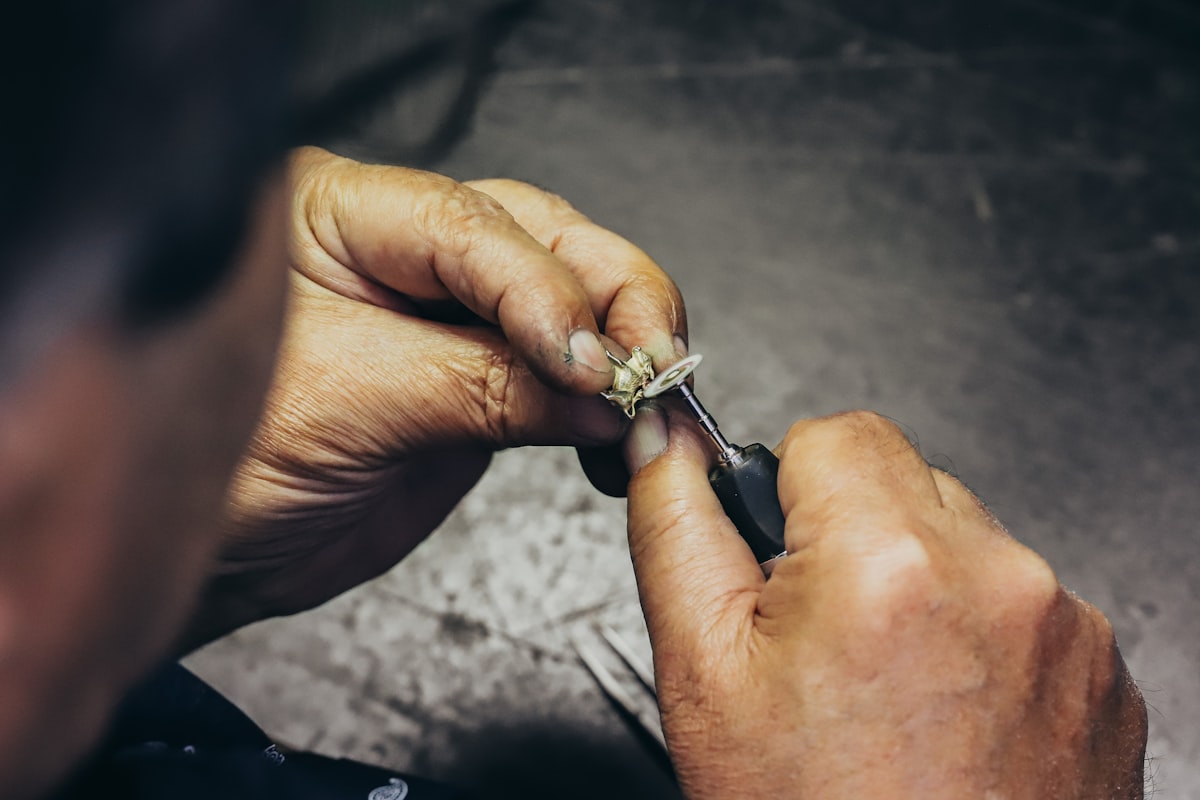 Hands stringing beads
